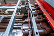 Production line or conveyor belt of metal tile for roof production. Metalwork factory. Metal sheet profiling machine.