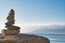 Stacked Stones On A Rock, Looking Out At The Irish Hills From Morro Bay, California.