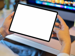 Close-up image of a man's hands holding digital tablet