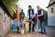 © Halfpoint - Diverse group of happy volunteers cleaning up street, community service concept
