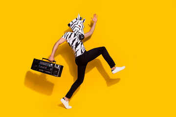 Poster - Full length profile side photo of bizarre guy in zebra mask hold boom box step discotheque isolated over shine yellow color background