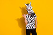 Photo of eccentric funky man wear zebra print t-shirt mask pointing thumb finger empty space isolated yellow color background