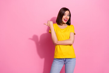 Sticker - Portrait of attractive funky cheerful girl demonstrating copy space isolated over pink pastel color background