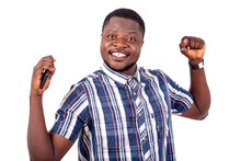 Close Up Of Happy Young Man With Cellphone Showing Victory Gesture.