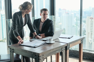 Two businessman and businesswoman couple meeting in co working space at sky lounge