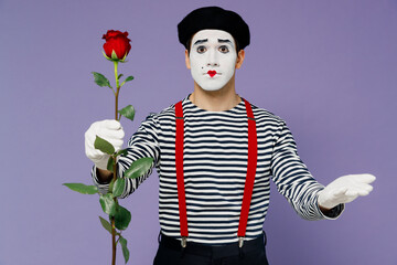 Canvas Print - Charismatic amazing marvelous romantic young mime man with white face mask wears striped shirt beret holding giving rose flower to you isolated on plain pastel light violet background studio portrait.