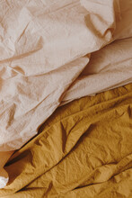 Peachy beige and ginger bed linen cloth. Crumpled blanket, textile pattern