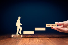 Change Mindset Lead To Be Successful. Concept With Wooden Pieces Of Blocks And Person Representing Soar To Success. Helping Hand Of Coach, Mentor Or Another Motivating Person.