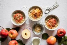 Studio Shot Of Bowls Of Fresh Porridge With Gala Apples