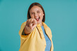 © Drobot Dean - Young white woman wearing shirt laughing and pointing finger at camera