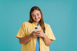 © Drobot Dean - Young white woman wearing shirt smiling and using cellphone