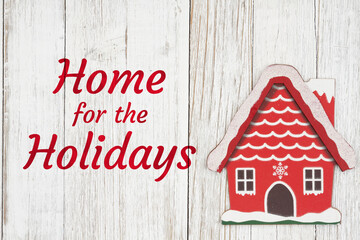 Wall Mural - Home for the holidays with winter house on weathered wood