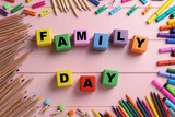 Fototapeta Młodzieżowe - International Family day. Flat lay composition with cubes, pencils, crayons and clothespins on pink wooden background