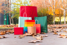 Christmas Gifts Bags And Boxes On Footpath In Autumn