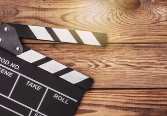 Film clapper board on wooden background. Cinema industry, entertainment. Top view