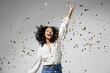 Happy woman at celebration party with confetti falling everywhere on her, Birthday or New Year eve celebrating concept