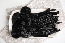 Tasty Black Liquorice Candies On White Wooden Table, Top View