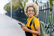 © Westend61 - Woman with backpack and mobile phone on footpath