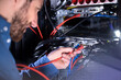 © Westend61 - Male IT specialist installing patch cord cable in server rack in data center