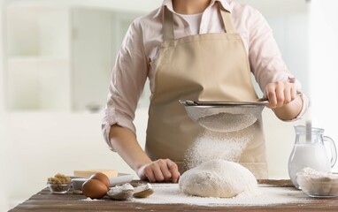 Canvas Print - beautiful mature woman stays home, in kitchen cooking.  baking bakery for dinner in house