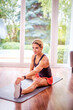 © gzorgz - Woman stretching after full body workout at home on the yoga mat