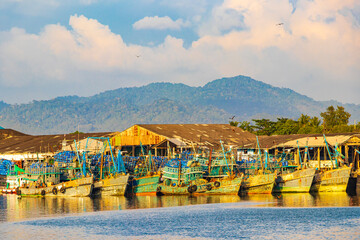 Industrial port Ranong and old fisher boats landscape panorama Thailand.