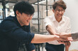 © chachamp - Happy businessman hand touch with team in office