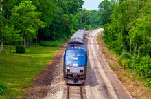 Amtrak Passenger Train Traveling From Chicago, Illinois To Detroit, Michigan Through Verdant Michigan Countryside