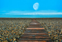 Wooden Plank Path Leading To The Ocean On Moon Background