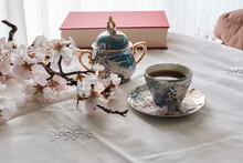 Still Life Of A Book, Coffee Cups And Almond Blossoms. Reading C