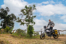 Man Posing On His Scrambler Type Off Road Motorcycle In Thailand