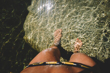 Goosebumps on Tan Legs looking down into clear sunkissed water
