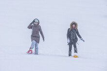 Couple Snowshoeing Through Snowy Field