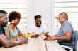 © PICHA - Friends playing cards while enjoying wine at home