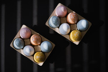 High Angle Of Colorful Easter Eggs In Egg Carton On Black Background