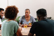 © PICHA - Friends playing cards while enjoying wine at home