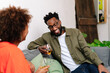 © PICHA - couple sitting on a couch having drinks