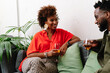 © PICHA - couple sitting on a couch having drinks