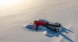 © Cavan Images - Child making a snow angel in an open snowy field in the morning sun.