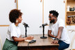© PICHA - A Black Woman interviewing a guest for a podcast