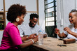 © PICHA - Friends playing domino game at home