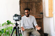 © PICHA - A Black man recording in a video interview