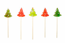 Five Colorful Lollipops In The Shape Of A Christmas Tree On A White Background. Isolate. Red And Green Lollipops.