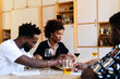 © PICHA - Friends having dinner