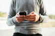© Cavan Images - Close-up of a man using smartphone
