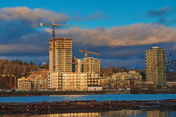 Wall Mural - 
Construction of a new high-rise buildings in the city side of the riverbank of Vancouver City
