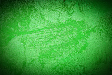 Texture of green decorative plaster or concrete with vignette.