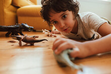 Little Boy Playing With His Toys At Home