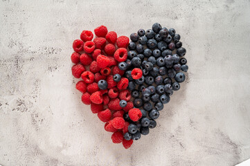 Wall Mural - Raspberry and blueberry heart. Healthy food, nutrition and detox concept. Top view.