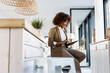 © Westend61 - Afro businesswoman using digital tablet sitting in office